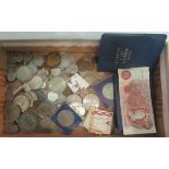 A box containing a quantity of miscellaneous coinage.