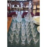 A quantity of glassware, comprising: two decanters and a collection of wine,
