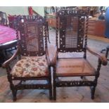 A near matching pair of 19th century and later profusely carved oak and walnut carver chairs,