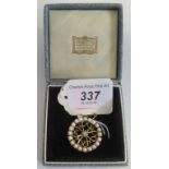 A 14 carat gold diamond and pearl circular brooch,