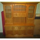 A large contemporary oak dresser, the inverted break-front upper section,