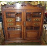 An Edwardian oak two door wall hanging display cabinet,