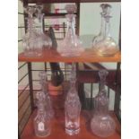 A collection of twelve various cut moulded and etched glass decanters, various sizes.