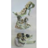 A collection of three Lladro figures, comprising: Boys with dogs & puppies,