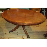 A reproduction mahogany and inlaid oval coffee table on quadruple base.