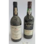 A bottle of Graham's 1975 Vintage Port, together with a bottle of Blandy's Madeira Wine.