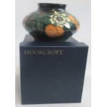 A Moorcroft Passion Fruit pattern vase of lobed pot bellied form 12cm high.