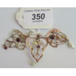 An Art Nouveau garnet and blister pearl openwork pendant,