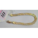 A 9 carat gold three colour multi strand twisted bracelet, 7.3g.