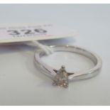 A single stone diamond ring, the pear shaped diamond in simple claw mount,