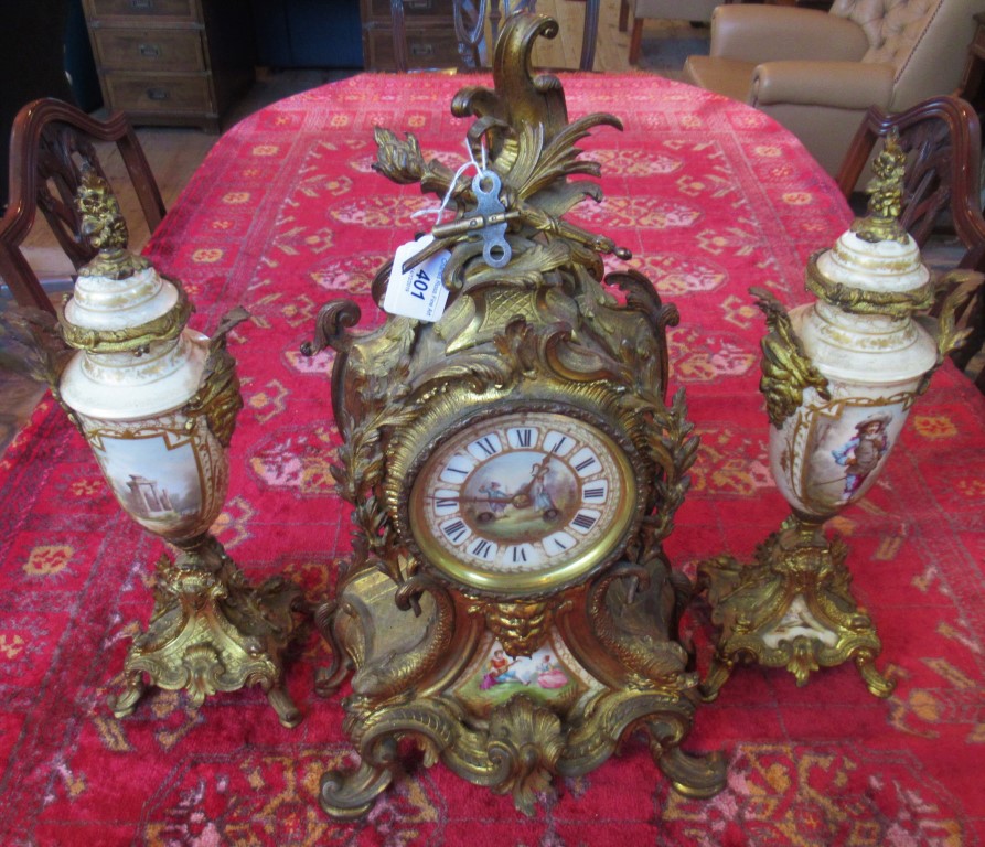 A late 19th/early 20th century gilt metal clock garniture,