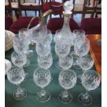A quantity of glassware, comprising: two decanters and sixteen wine glasses.