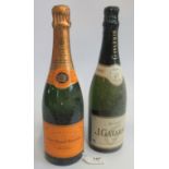 A bottle of J. Gavarnie Champagne, together with a bottle of Veuve Clicquot Ponsardin Champagne.