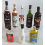 A collection of 8 bottles of various spirits, to include: Smirnoff Vodka, Captain Morgan Rum,