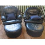 A pair of blue leather armchairs with matching footstools.