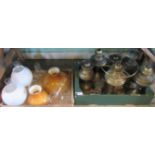 Two boxes containing a large quantity of brass oil lamps, together with shades and chimneys.