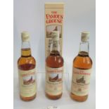 Three bottles of Famous Grouse Scotch Whisky.