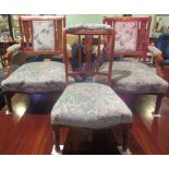 A pair of Edwardian mahogany inlaid and upholstered fireside chairs,