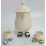 A Carlton Walking Ware lidded jug, together with two Walking Ware egg cups.