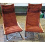 A pair of mid-20th century folding lounge chairs, with hardwood arms,