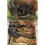 Two boxes containing a quantity of carved wooden figures, together with associated metal figures,