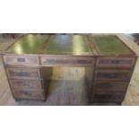 A 20th century campaign desk, having a three panelled tooled scriber, central drawer,