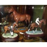 A Beswick figure of Arkle on a wooden plinth, together with two other horse related figures.