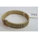 A 9 carat gold bangle. Condition Report: 25.6 grams gross.