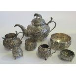 A collection of seven pieces of Indian metalware, to include: teapot, sugar bowl,