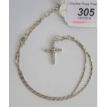 A diamond set cross and fancy link chain, both marked 750, 11.4g.