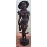 A 20th century hardwood figure of a Balinese lady, 98cm high.