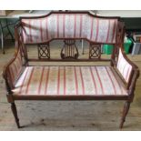 An Edwardian mahogany inlaid and upholstered two seater salon settee.