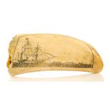 Ø A MID-19TH CENTURY SAILOR DECORATED SCRIMSHAW WHALE'S TOOTH