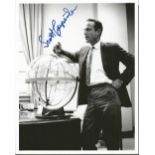 Scott Carpenter signed 10 x 8 b/w photo. Full length pose in business suit leaning against space