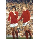 Denis Law signed 12x8 colour photo in Man Utd kit standing on the pitch with George Best. Good