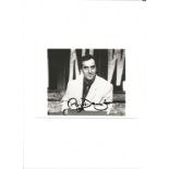 Angus Deayton signed 7x5 inch black and white, sat behind 'Have I Got News For You' desk, signed