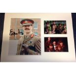 Stephen Fry signed colour photo. Mounted alongside 2 other colour photos. Mounted to approx