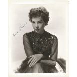 Leslie Caron signed 10 x 8 b/w vintage full length photo. Good Condition. All signed pieces come