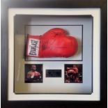 Mike Tyson signed boxing glove in a presentation case. Good Condition. All signed pieces come with a