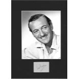 David Niven signature piece mounted below b/w photo. Approx. overall size 16x12. Good Condition.