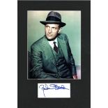 Robert Stack signature piece mounted below colour photo. Approx overall size 14x10. Good