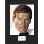 Roger Moore signature piece mounted below colour photo. Approx overall size 14x11. Good Condition.