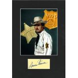 Dennis Weaver signature piece mounted below colour photo. Approx overall size 16x11. Good Condition.