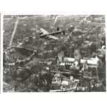 World War Two 7x9 vintage b/w photo picturing a Avro Lancaster Bomber in flight over Lincoln