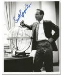 Scott Carpenter signed 10 x 8 b/w photo. Full length pose in business suit leaning against space