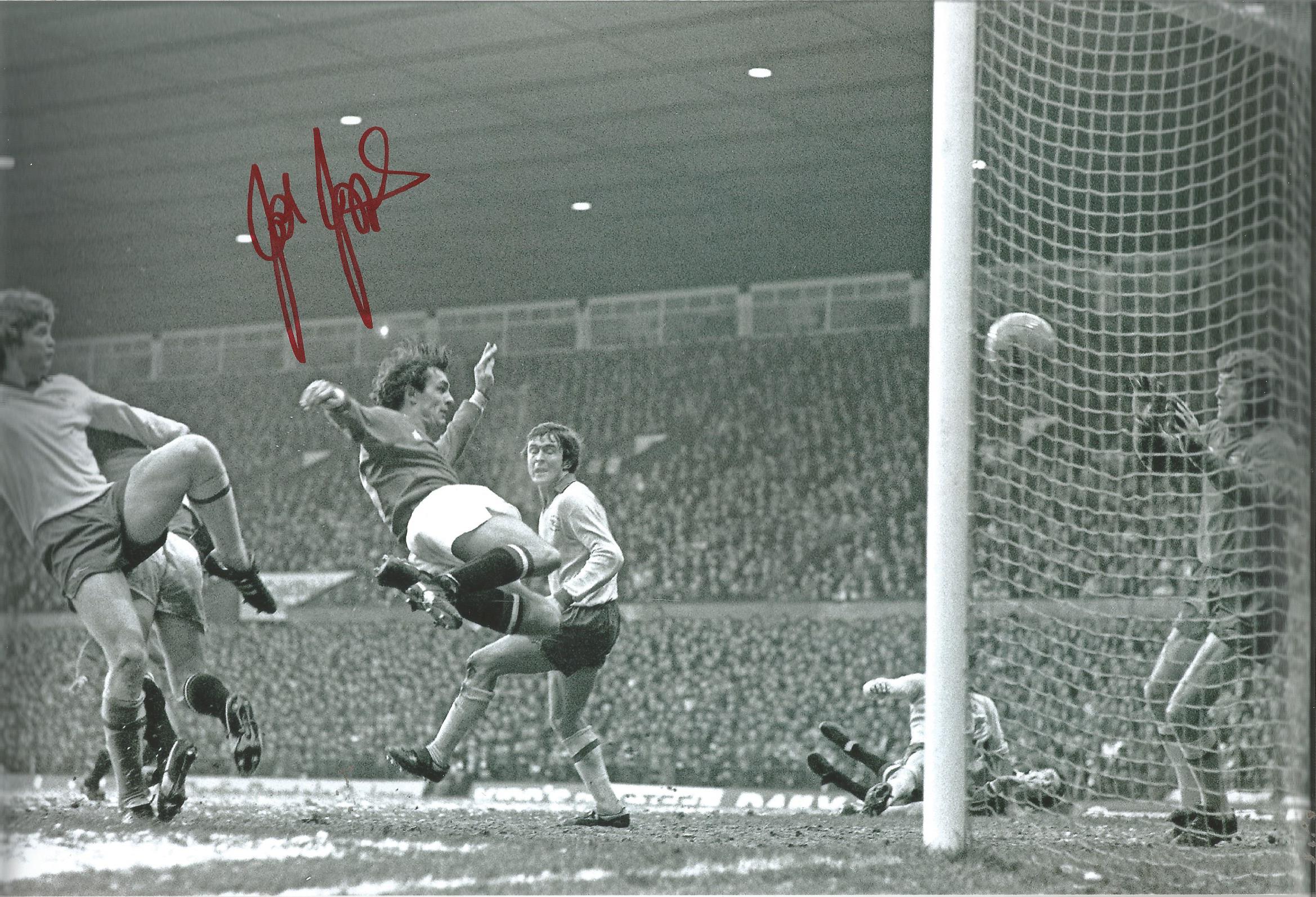 Football Autographed 12 x 8 photo, depicting Manchester United striker Joe Jordan acrobatically