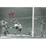 Football Autographed 12 x 8 photo, depicting Manchester United striker Joe Jordan acrobatically