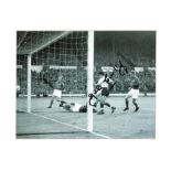 Football John Connelly signed 10x12 mounted b/w photo pictured in action for England. Good condition