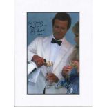 Roger Moore and Tanya Roberts signed colour photo. Mounted to approx size 12x10. Good Condition