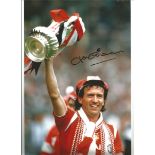 Autographed John Gidman photo, a superb image depicting the Manchester United full-back holding